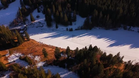 High-angle drone shot of the frozen Grubsee lake in Germany. People enjoying Stock Footage 325860791