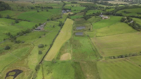 A high angle drone shot of the green farmland in villages. Stock Footage 275930657