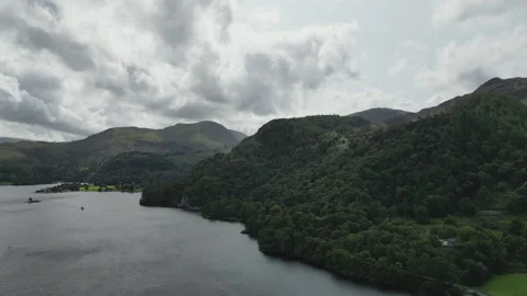 A high angle drone shot of the high mountains with trees and lake. Stock Footage 251597029
