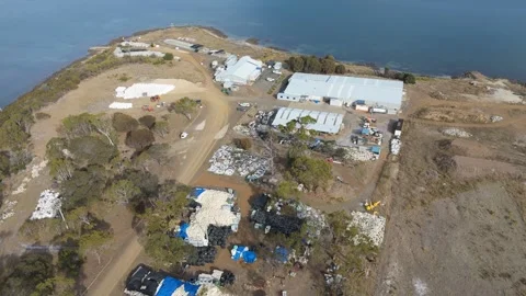 High-angle drone shot of industrial storage areas with white bags and equipment. Vídeo Stock 332542710