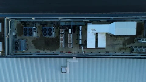 High angle drone shot of mechanical cooling units and ventilation ducting on a Stock Footage 333542432