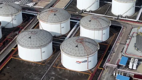 High-angle drone shot of oil storage tanks and pipeline network at industrial Stock Footage 332382657
