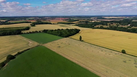 High angle drone shot over patchwork English countryside on a sunny day. 4k Stock Footage 147151169