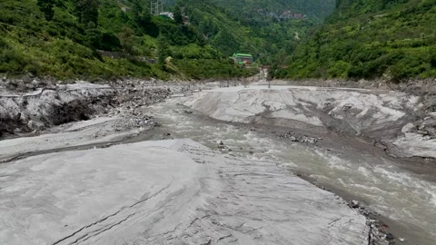 High angle drone shot over extensive silt deposits and eroded river bank Stockbeeldmateriaal 345276395