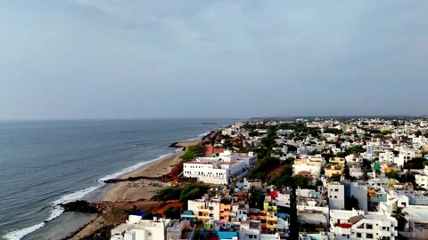 A high-angle drone shot reveals Puducherry's beautiful beach and sprawling Stock Footage 314371739