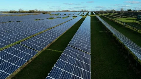 High angle drone tracking shot of a large scale ground mounted solar array in Stock Footage 337004916