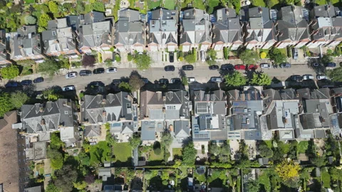 A high angle drone video of rows of houses in an English suburb in summer. Stock Footage 275540930