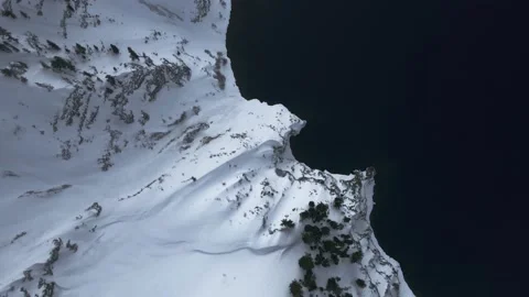 High angle drone video of snow-covered shores of Crater Lake, Oregon, USA Video stock 194181929