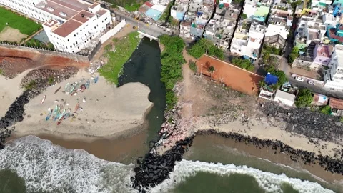 A high-angle drone view captures the meeting point of a river and the sea Stock Footage 315129096