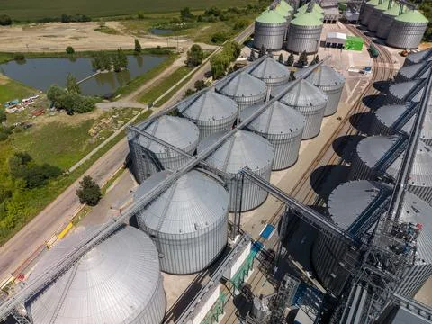 High Angle Drone View of Extensive Agroindustrial Metal Grain Silo Array Stock Photos