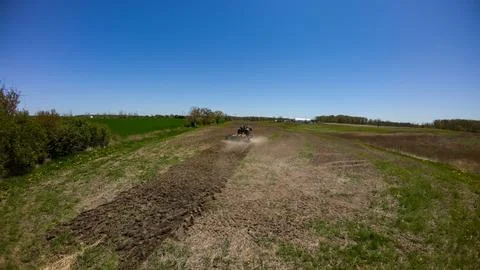 High angle drone view of a farm tractor prepping a soil field Foto stock