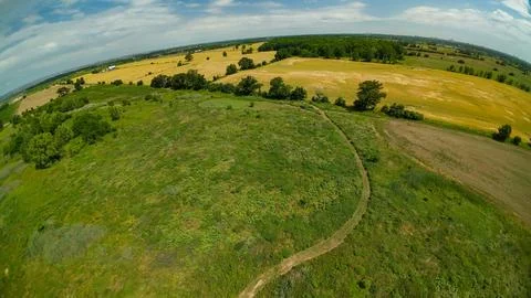 High angle drone view of a food plot and a distant farm tractor Foto stock