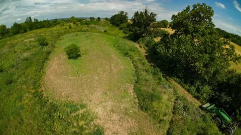 High angle drone view of a food plot and a moving tractor Foto stock