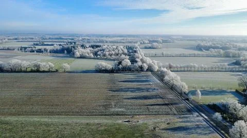 High Angle Drone View of Frozen Winter Forest and Farmland Stock Photos
