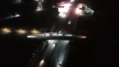 High angle drone view of illuminated highway interchange at night. Video stock 329180306