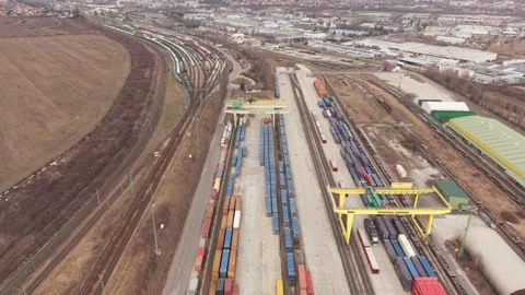 High angle drone view of a large intermodal freight terminal with rows of cargo Stock Footage 331612842