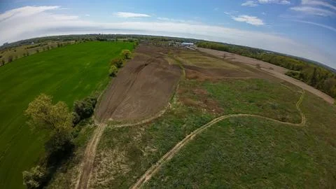 High angle drone view of a moving tractor prepping a soil field Stock Photos
