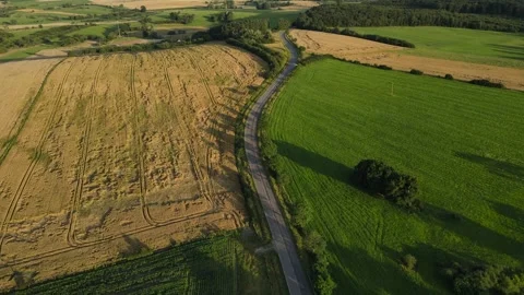 High-angle drone view of patchwork farmlands at golden hour, Moselle, Video stock 291935723