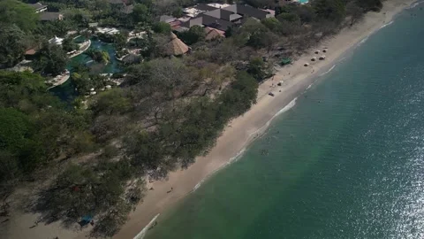 High angle drone view of Playa Conchal tilt down on turquoise water Costa Rica Stock Footage 330037575