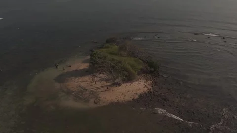 High Angle Drone View of Small Tropical Islet Surrounded by Rippling Water and Stock Footage 337199806