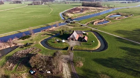 High angle drone view of a straight Dutch canal cutting through vibrant Stockbeeldmateriaal 332741782