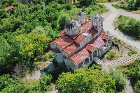 High angle drone view of tilted leaning stone church of Agia Paraskevi in a.. 库存照片