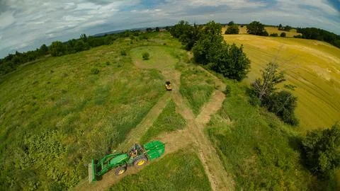 High angle drone view of a tractor and an ATV beside a field Foto stock