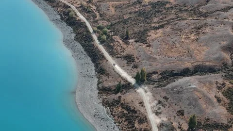 High-Angle Drone View of Vehicle Driving on Highway beside Lake Tekapo Stock Footage 273288726