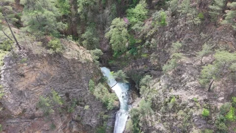 High Angle Drone View Of Waterfall Flowing Through Rocky Mountain Canyon 4K Stock Footage 333598036