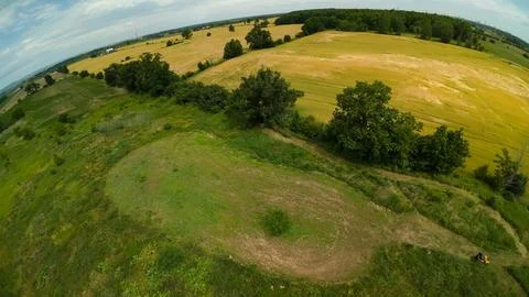 High angle drone view of a yellow ATV by a food plot and farm fields Foto stock