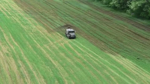 A High Angle Establishing Shot of a Manure Spreader Stock Footage 196199172