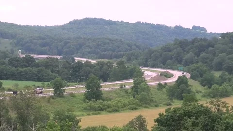 A High Angle Establishing Shot of Traffic on a Four Lane Road Vídeo Stock 157826114