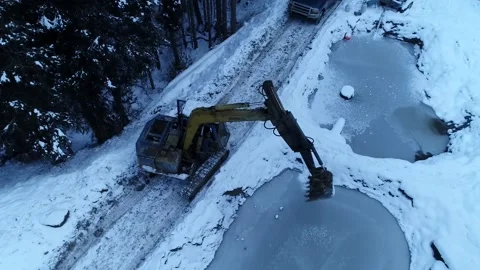 High Angle Excavator Breaking Pond Ice Drone Shot Stock Footage 146612903