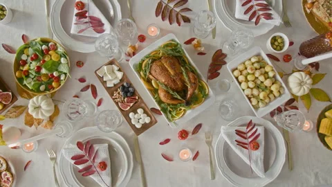 High Angle of Fall Table Setting Displaying Baked Turkey, Salad, Baby Potatoes Stock Footage 317998431
