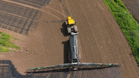 High angle farm machinery performing manure fertilizer application during field Stock Footage 340553394