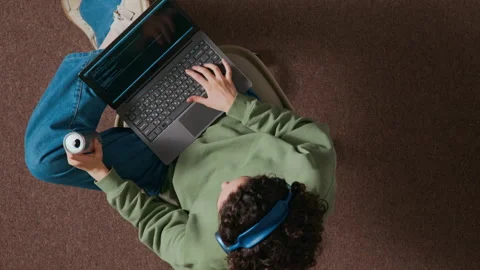 High Angle of Female Programmer with Laptop Writing Code and Drinking Beverage Stock-Footage 312448886
