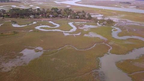High angle flyover of meandering river through coastal flood plain. Stock Footage 106026849