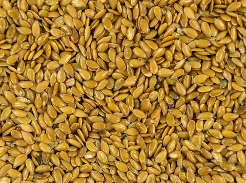High-angle full frame macro shot of golden flax seeds creating a dense natu.. Stock Photos