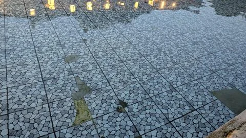 High angle full frame shot captures clean water rippling over a geometric g.. Stock Photos