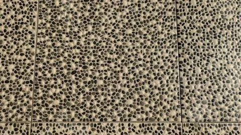 A high angle full frame shot displays pebble stone pattern floo Stock Photos