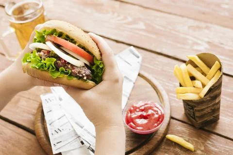 High angle hands holding burger burger fries Stock Photos
