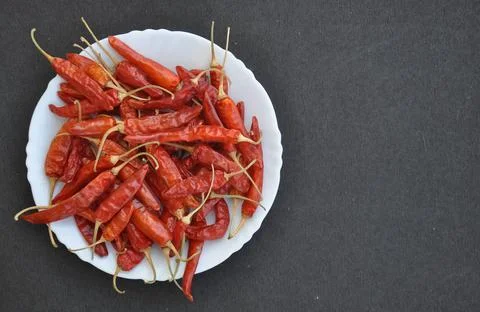 High angle of heap of red chilli peppers on the white plate  Stock Photos