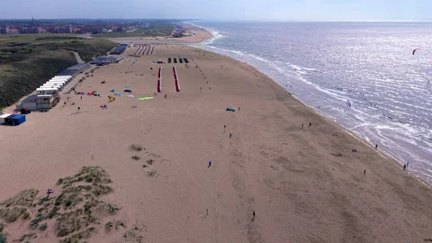 High angle horizontal aerial drone video clip of sandy beach, beach cabins Stock Footage 342698382