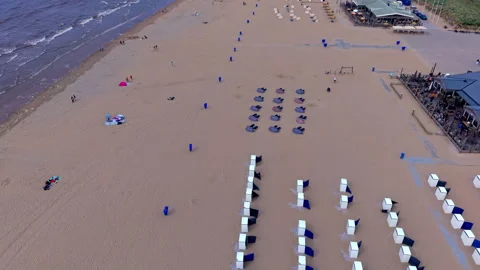 High angle horizontal aerial drone video clip of beach cabins, sun loungers Stock Footage 342739814