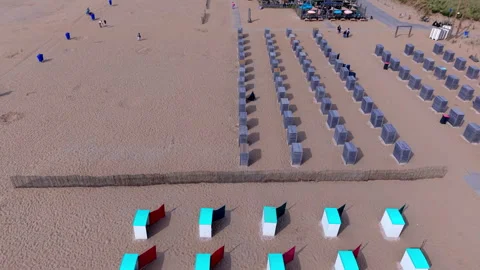 High angle horizontal aerial drone video clip of beach cabins, coloured Vídeos de archivo 342759600