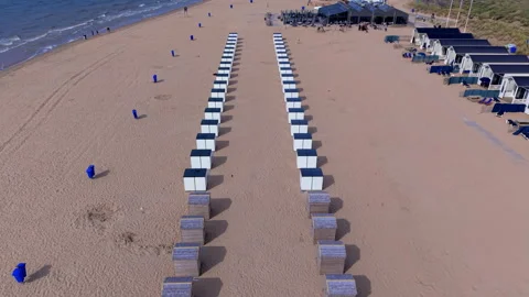 High angle horizontal aerial drone video clip of beach cabins, wooden huts Видео 342760285
