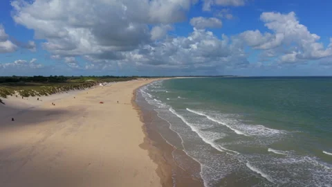 High angle horizontal aerial drone video clip of sandy beach, North Sea wave Vídeos de archivo 342994979