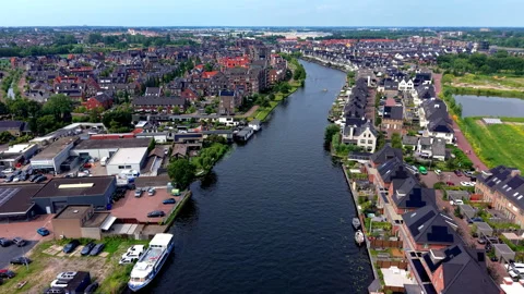 High angle horizontal aerial drone video clip of river canal, residential Vídeos de archivo 342994992