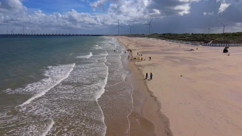 High angle horizontal aerial drone video clip of sandy beach, North Sea wave Vídeos de archivo 342995030