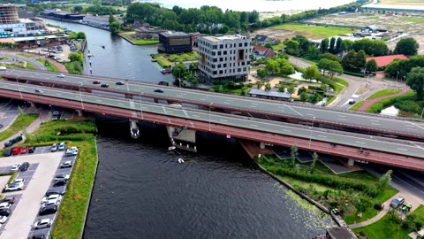 High angle horizontal aerial drone video clip of river canal, highway bridge Video stock 342995607